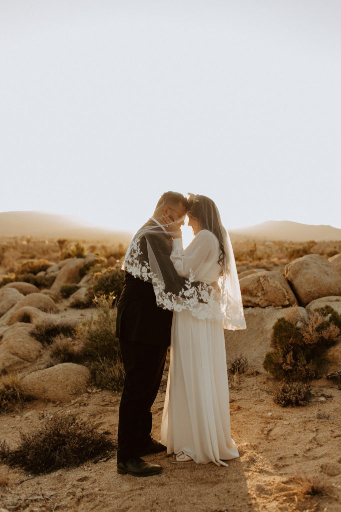 Newly married couple posing during photo session with Temecula wedding photographer
